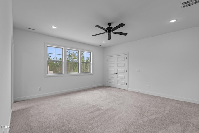 carpeted empty room with ceiling fan