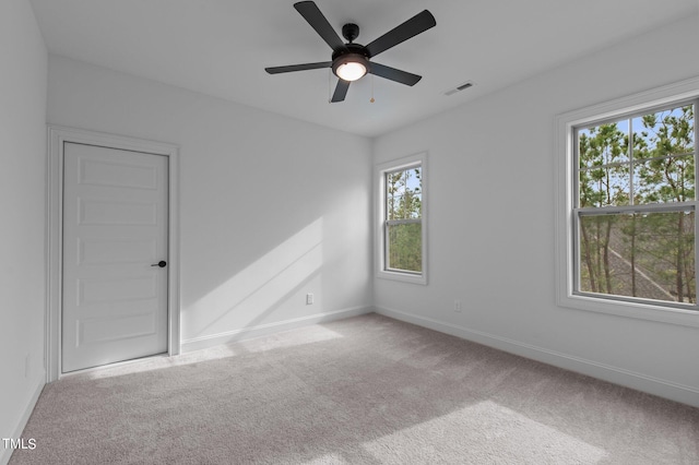 spare room with light carpet and ceiling fan