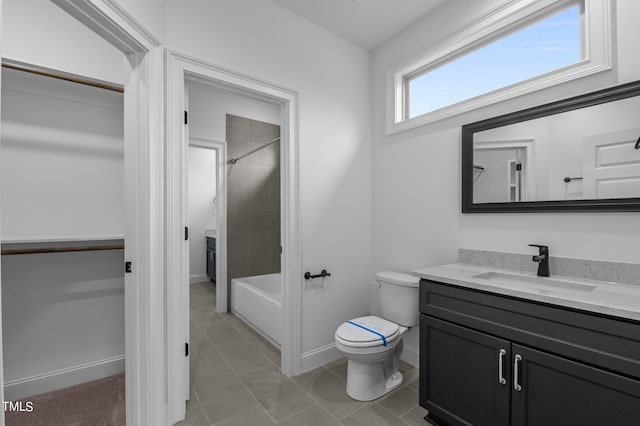 full bathroom with tile patterned flooring, vanity, toilet, and tiled shower / bath