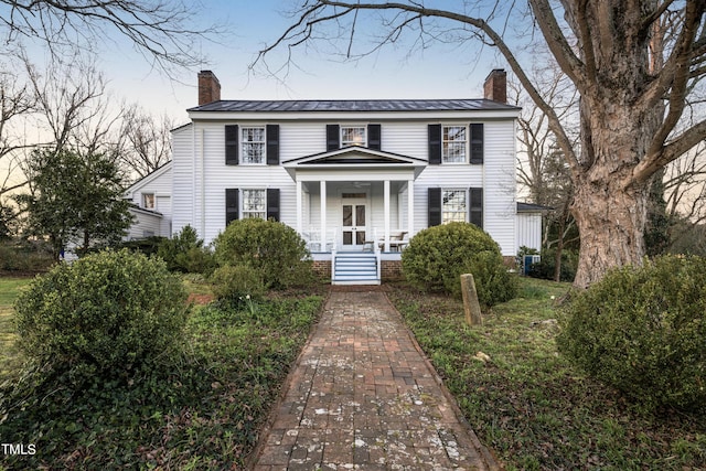 6720 Mebane Oaks Rd, Mebane, NC 27302 - colonial home featuring a chimney, a standing seam roof, covered porch, and metal roof
