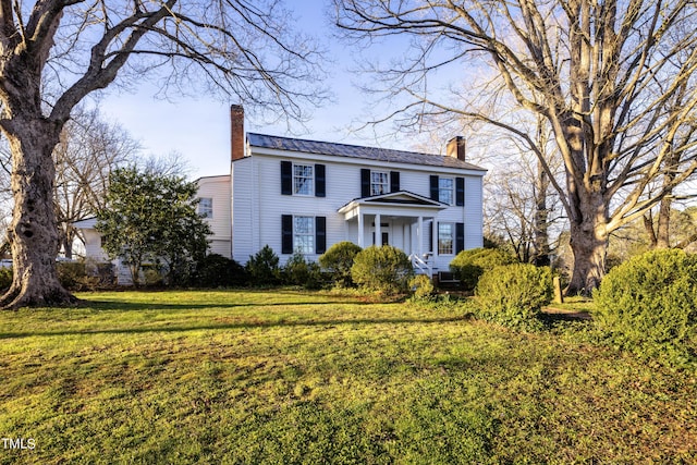 6720 Mebane Oaks Rd, Mebane, NC 27302 - view of front of house with a chimney, metal roof, and a front lawn