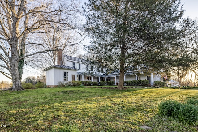 6720 Mebane Oaks Rd, Mebane, NC 27302 - traditional-style house with a chimney, a standing seam roof, a front lawn, and metal roof