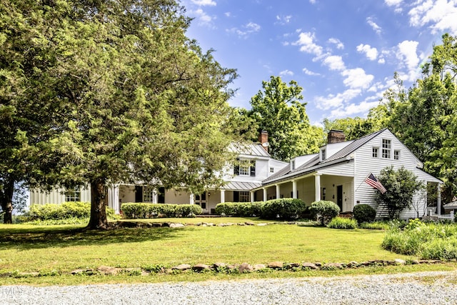 6720 Mebane Oaks Rd, Mebane, NC 27302 - view of front facade featuring a chimney, metal roof, a front yard, and a standing seam roof