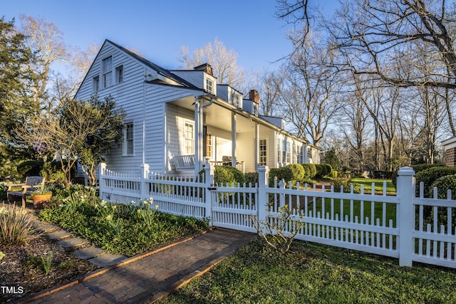 6720 Mebane Oaks Rd, Mebane, NC 27302 - view of side of property with a chimney, a porch, and a fenced front yard