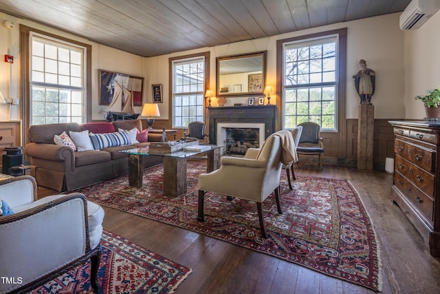 6720 Mebane Oaks Rd, Mebane, NC 27302 - living area with a wainscoted wall, hardwood / wood-style floors, a wall unit AC, and a fireplace