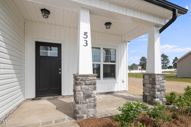 view of exterior entry featuring a porch