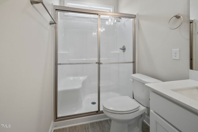 bathroom featuring an enclosed shower, oversized vanity, and toilet