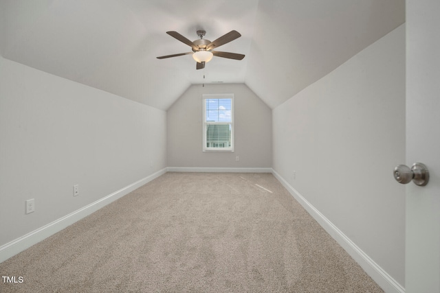 bonus room featuring vaulted ceiling, light carpet, and ceiling fan