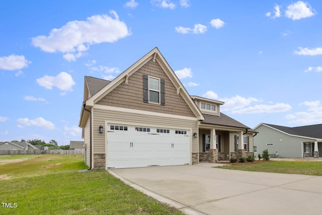 craftsman house featuring a garage and a front lawn