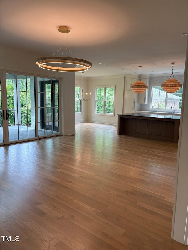 2227 Wheeler Rd, Raleigh, NC 27607 - unfurnished living room with wood finished floors, healthy amount of natural light, and baseboards