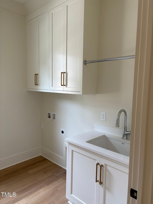 2227 Wheeler Rd, Raleigh, NC 27607 - washroom with cabinet space, hookup for an electric dryer, washer hookup, baseboards, and light wood-style floors