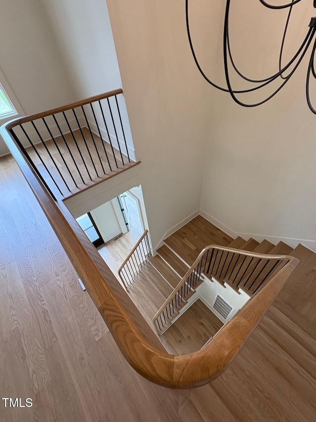 2227 Wheeler Rd, Raleigh, NC 27607 - staircase with wood finished floors and baseboards
