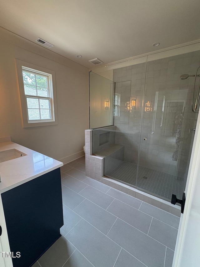 2227 Wheeler Rd, Raleigh, NC 27607 - full bathroom with vanity, a shower stall, tile patterned flooring, toilet, and baseboards