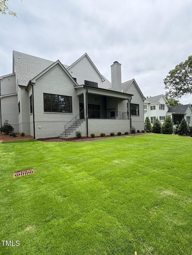 2227 Wheeler Rd, Raleigh, NC 27607 - back of property featuring a chimney and a lawn