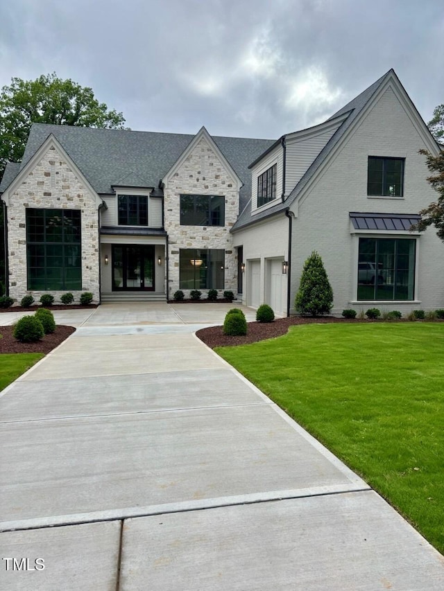2227 Wheeler Rd, Raleigh, NC 27607 - view of front of property with a garage, stone siding, a front yard, and concrete driveway