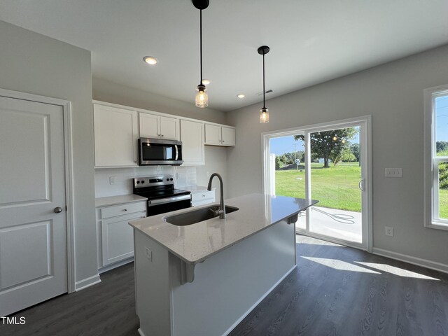 kitchen featuring backsplash, stainless steel appliances, sink, white cabinets, and dark wood-type flooring