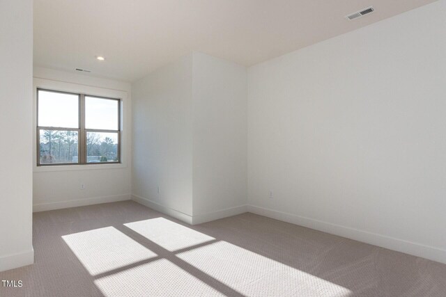 empty room with light colored carpet