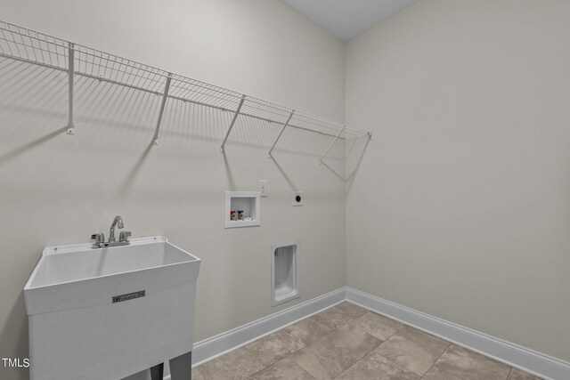 laundry area with sink, hookup for an electric dryer, washer hookup, and light tile patterned floors