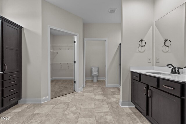 bathroom with vanity, toilet, and tile patterned floors