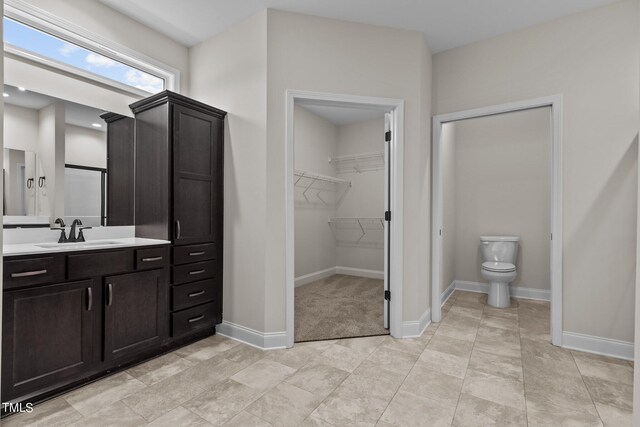 bathroom featuring tile patterned flooring, toilet, and vanity