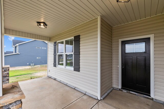 view of exterior entry featuring a patio area