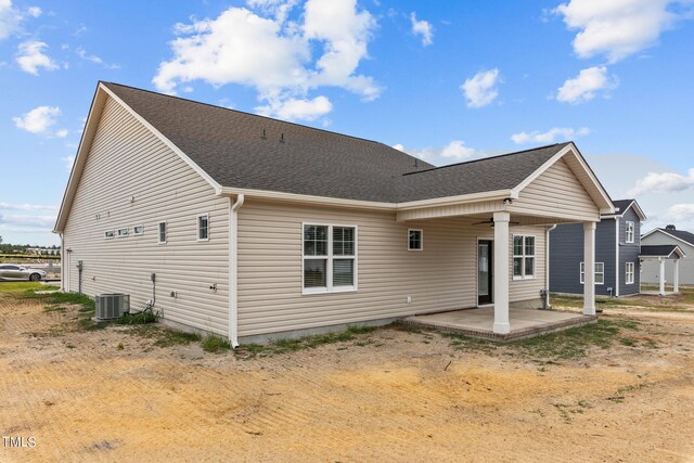 rear view of house featuring a patio and central AC