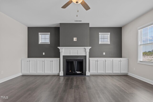 unfurnished living room with hardwood / wood-style flooring and ceiling fan