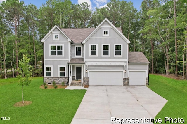 view of front of property featuring a garage and a front yard