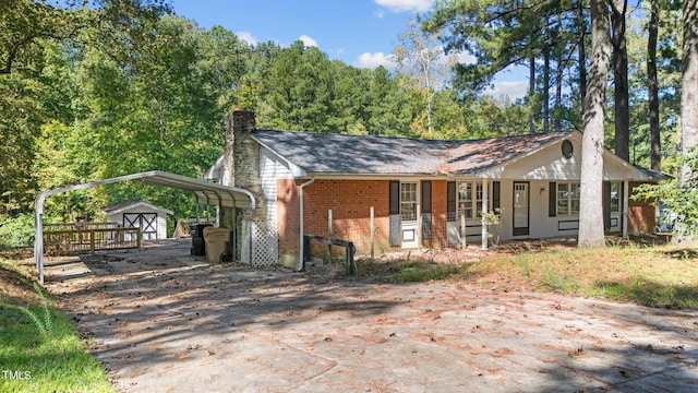 view of front of property featuring a porch and a carport