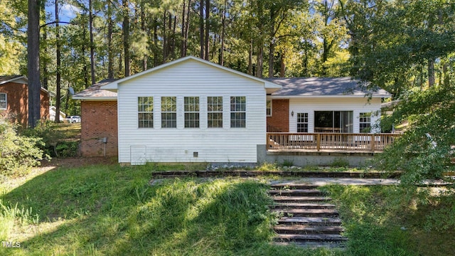 back of house with a deck