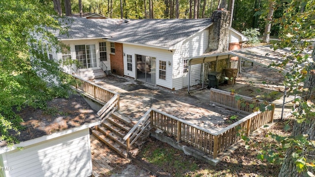 back of house with a wooden deck