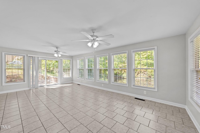 unfurnished sunroom with ceiling fan