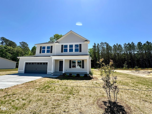 view of front of house featuring a front lawn and a garage