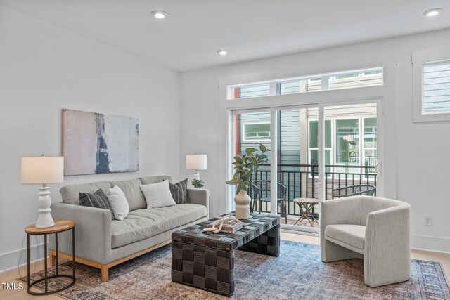 living area with recessed lighting, baseboards, and wood finished floors