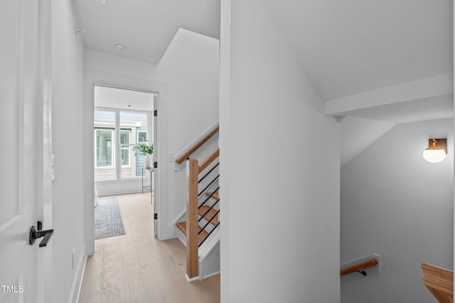 staircase featuring vaulted ceiling and wood finished floors