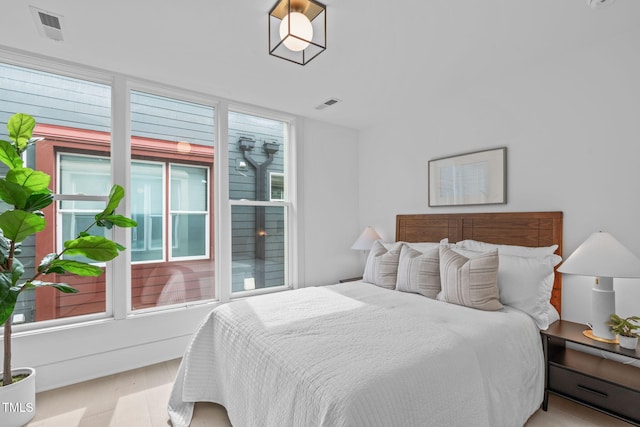 bedroom with visible vents and wood finished floors