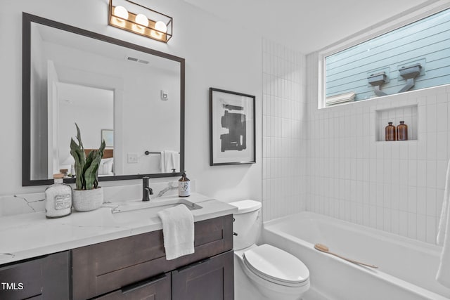 bathroom featuring bathtub / shower combination, visible vents, vanity, and toilet