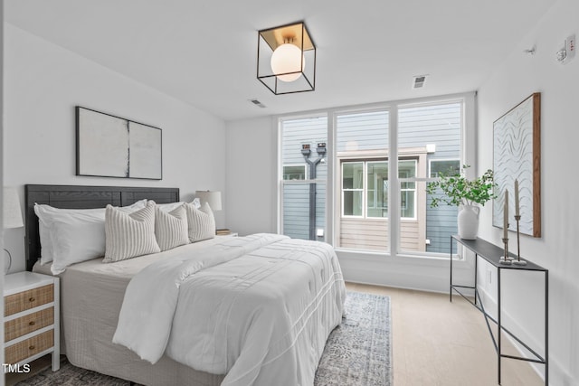 bedroom with visible vents and light wood finished floors