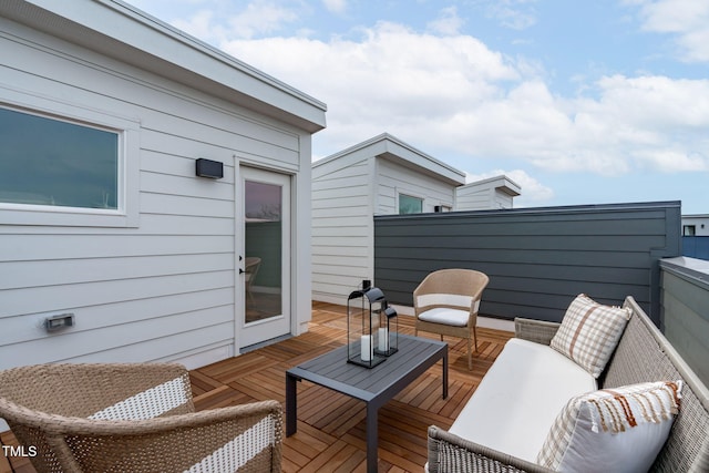 wooden deck with an outdoor living space