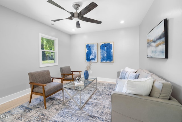 living room featuring ceiling fan and light wood-type flooring