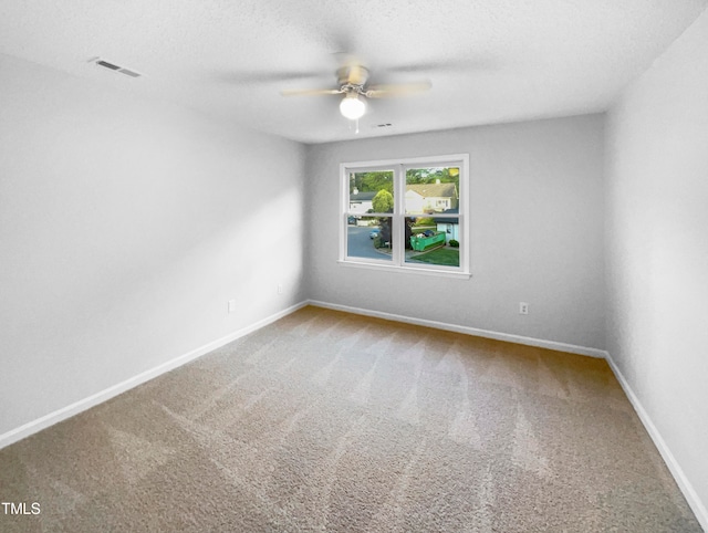 unfurnished room with ceiling fan, carpet, and a textured ceiling