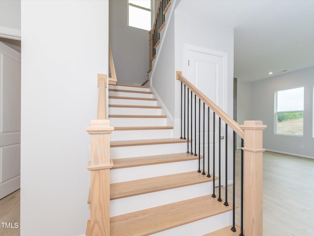 stairway featuring wood-type flooring