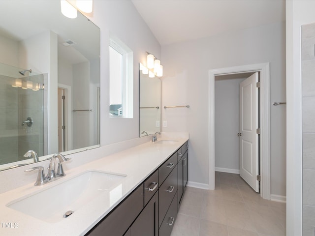 bathroom with walk in shower, vanity, and tile patterned flooring