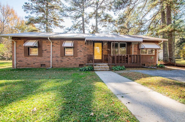 view of front of property with covered porch and a front yard