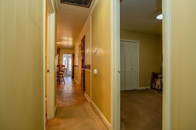 hall featuring light colored carpet