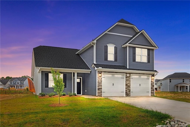 view of front of home featuring a lawn and a garage