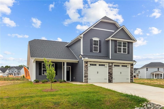 view of front of house featuring a front lawn and a garage