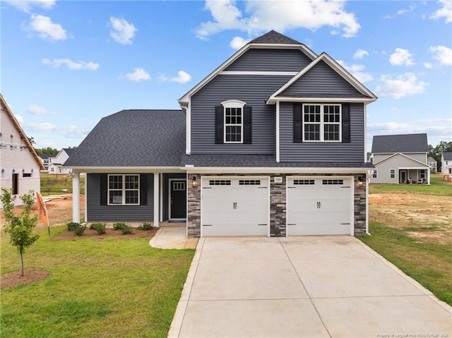 view of front of house featuring a front lawn and a garage