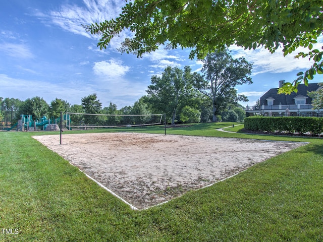 view of property's community featuring volleyball court, a playground, and a lawn