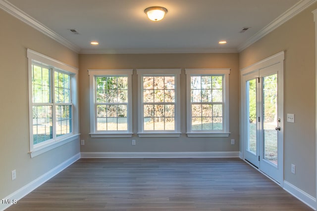 interior space featuring crown molding, a healthy amount of sunlight, and dark hardwood / wood-style flooring